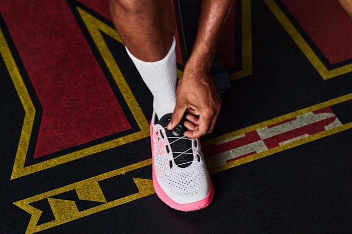 View of white and pink Under Armour shoe.